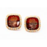 A pair of gold and carnelian intaglio dress studs, carved depicting profiles of Roman gods,