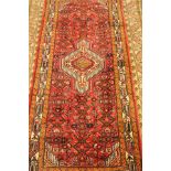 Red ground rug, hand knotted woollen,