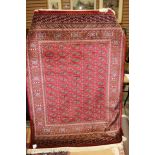 A contemporary machine made Bokhara red ground rug,