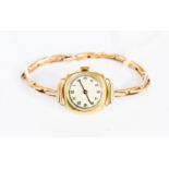 A ladies 9ct gold wrist watch, on yellow metal expander strap,