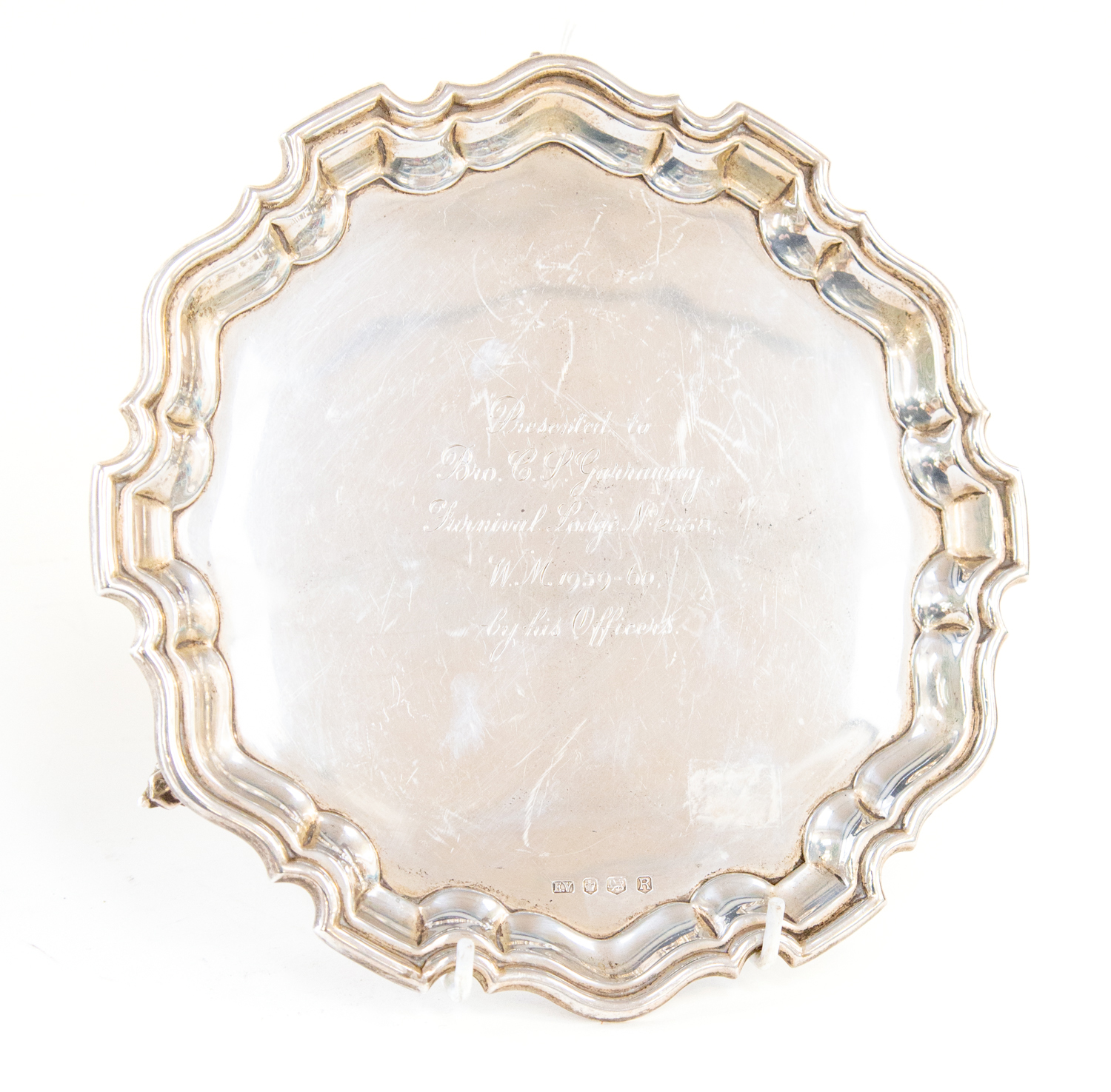 Masonic Interest: An Elizabeth II silver salver, pie crust rim on three scroll feet,