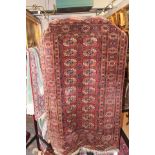 An old Bokhara crimson ground rug