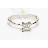 A diamond solitaire platinum ring, the princess cut diamond weighing approx 0.