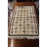 Small cream rug with multi-coloured cross pattern