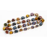 A tigers eye bead necklace, formed from a series of cuboid beads with chamfered corners,