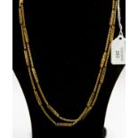 A gold-plated guard chain, comprising alternating pierced and snake chain links,