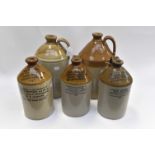 A collection of five various stoneware brewery flagons,