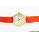 A 9ct gold cased Tissot watch (gents) with coral coloured leather strap,