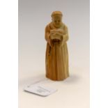 A Royal Worcester blush ivory candle snuffer modelled as a monk with book in hand,