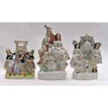 Three Victorian Staffordshire Flatback figure groups, comprising pocket watch holder,