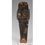 Egyptian Wood Shabti Ramesside Period, C. 1295 - 1070 B.C. An Egyptian wooden shabti covered in