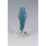 Egyptian Faience Shabti Ptolemaic Period, C. 300-32 BC. An upper section of a shabti figure with