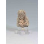 Upper half of a mould-made pale blue faience worker figure: wears tripartite wig with stripes