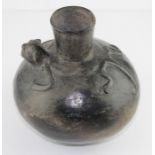 Pre-Columbian pottery, a Chimu blackware terracotta flask, an animal splayed out around the spout.
