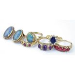 A 9ct. gold and opal ring and earrings en suite, the having oval cabochon opal in rub over setting
