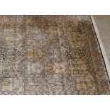 A part silk Persian style Tree of Life pattern rug, with five rows of panels depicting trees and