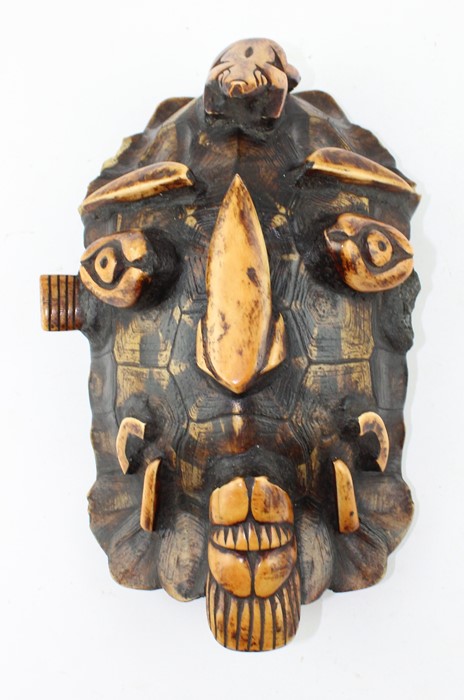 19th century tortoiseshell and stained bone tribal mask,  carved in relief with a face, 28 cm x 18