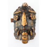 19th century tortoiseshell and stained bone tribal mask,  carved in relief with a face, 28 cm x 18