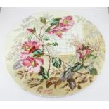 A large late 19th century Minton pottery circular plaque, painted with flowers and leaves in an