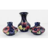 A near matched pair of William Moorcroft pottery vases, of squat  circular form in the Pansy