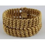 A fancy 18ct. yellow gold bracelet, fashioned as conjoined pairs textured rope twist 'links' ,