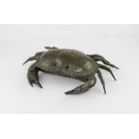 A Continental patinated white metal model of an 8 claw crab, realistically cast with glass eyes,