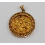A Chinese 18ct. yellow gold circular pendant, relief cast, chased and engraved with dragon to one