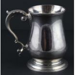 A George III silver pint tankard, assayed London 1761, makers mark "M.J", of baluster form, having