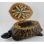 A late 19th century hardwood tea caddy, realistically carved as a tortoise, the hinged top opening