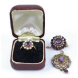 A 9ct. gold, amethyst and seed pearl ring, having raised claw set round cut amethyst surrounded by