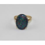 A 9ct. yellow gold and opal ring, set oval cabochon opal, impressed "9ct". (gross weight 2.5g)