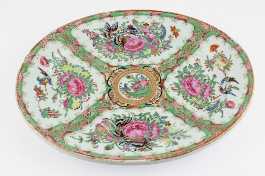 A Chinese Cantonese export oval platter in famille rose palette painted with flowers and - Image 2 of 3