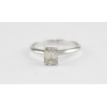 A platinum and solitaire diamond ring, four claw set emerald cut diamond (diamond weight approx. 1.1