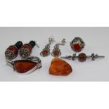 A silver and amber Art Nouveau style brooch, fashioned as stylised foliage set polished orange