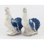 A pair of painted concrete doves, French early 20th century, white painted with blue wing and tail