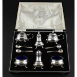 A 20th century cased Indian silver cruet set, comprising a pair of circular lidded mustard's with