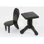 A late Victorian carved jet miniature pillar table and chair, both engraved with Whitby Abbey (2)