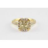 An 18ct. yellow gold diamond cluster ring, having fancy yellow cushion cut central diamond (