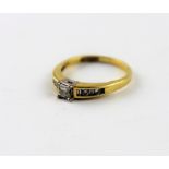 A yellow metal and diamond ring, having central claw set princess cut diamond of approx 0.25 carat,