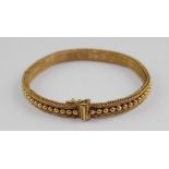 An 18ct. yellow gold fine mesh bracelet, having row of central raised beads along length of