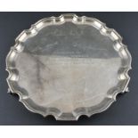 A silver circular salver, by Wakeley & Wheeler, assayed London 1971, having a stepped scroll border,