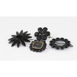 Three Victorian/ Edwardian French Jet brooches of flower head form together with an Edwardian jet