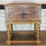 A 17th century carved oak bible box, with iron mounts and carrying handles, bearing old paper