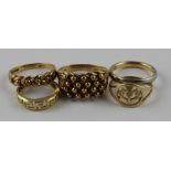 Three 9 ct. yellow gold rings. two of highly textured design, the other having pieced and engraved