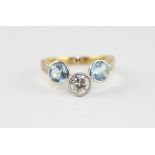 A yellow metal, diamond and aquamarine dress ring, the centre bezel set round old cut diamond (