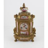 A 19th century French gilt metal and porcelain mounted mantle clock, with pink enamel dial and