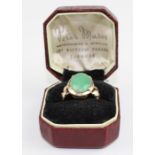 **REOFFER IN APR LONDON 120/180**A 14ct. yellow gold and jade ring, set oval cabochon green jade