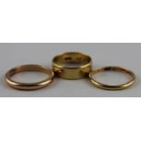 Two 18ct. yellow gold bands, both with shank impressed "18ct", (5.8g), together with an unmarked