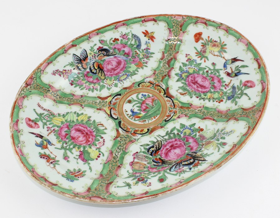 A Chinese Cantonese export oval platter in famille rose palette painted with flowers and