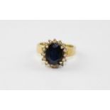 **REOFFER IN APR LONDON 120/180**An 18ct. gold, sapphire and diamond ring, raised head four claw set